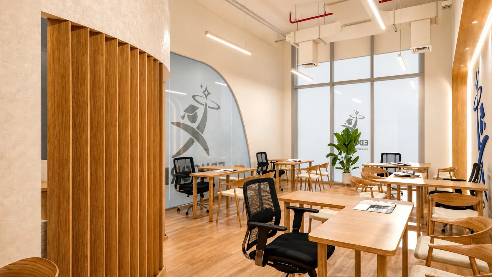 Curved timber screen dividing the Educore study floor beside a full-height window